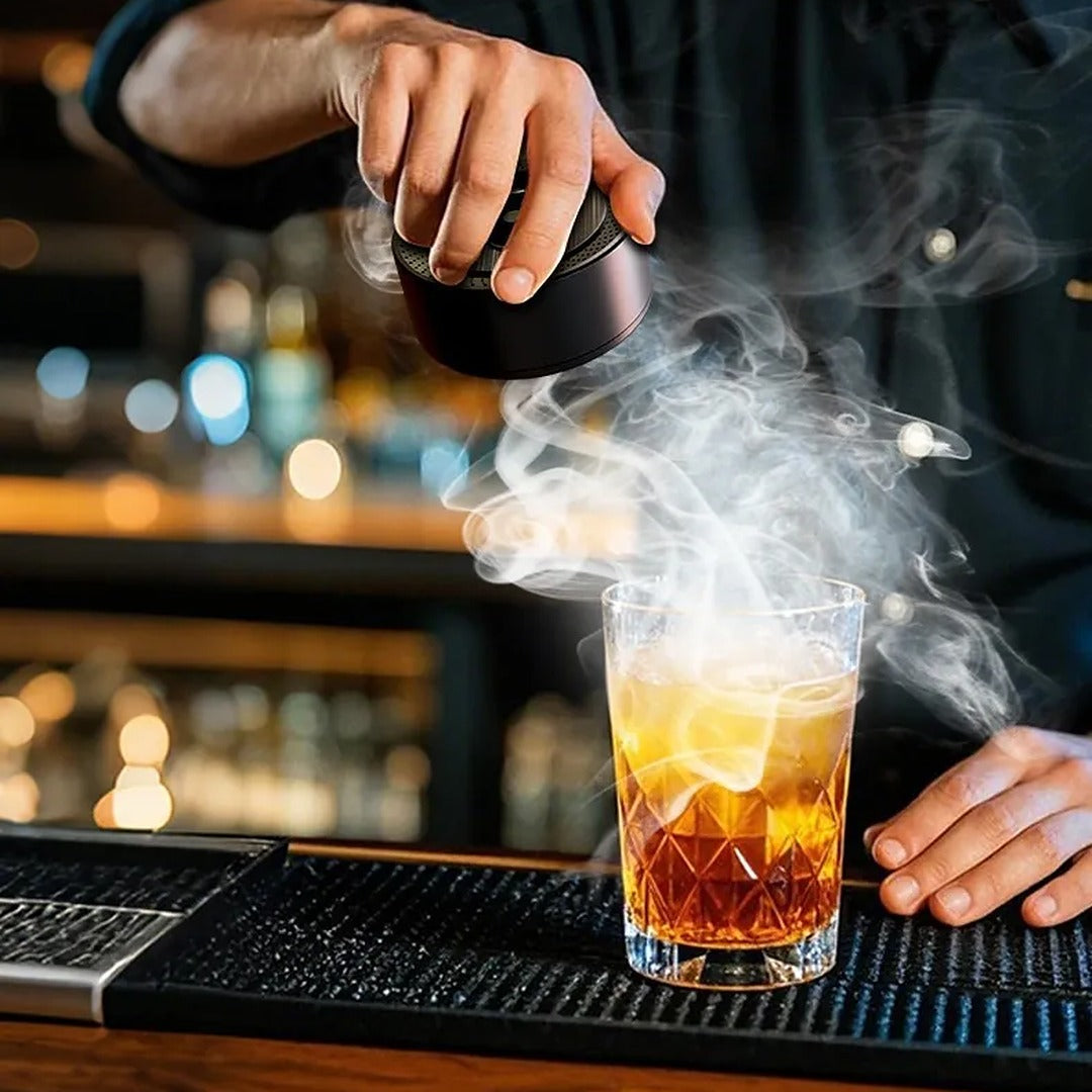 Bartender using the Brightwick smoker over a cocktail